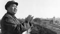 Mao Tse-Tung, chair of the Chinese Communist Party, on a balcony clapping his hands.