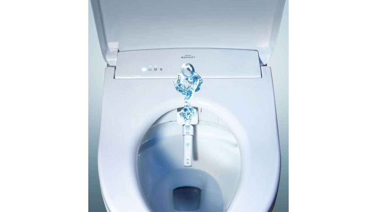 Photo of a bidet with the water running.
