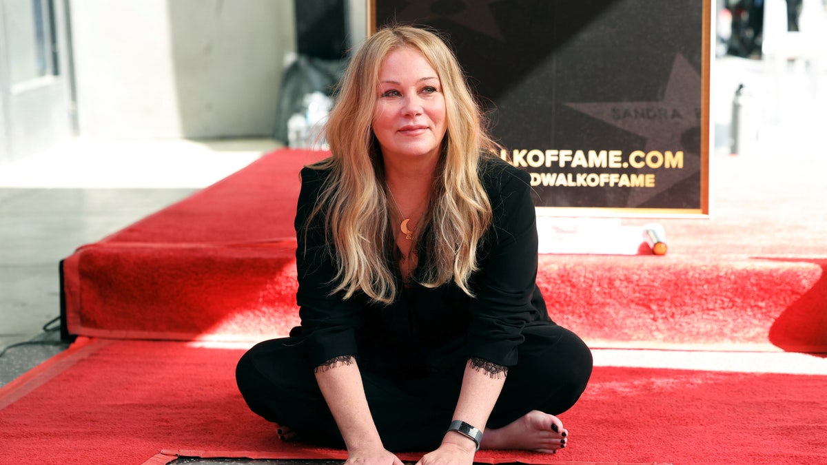 Christina Applegate with her hands on her Hollywood walk of fame star