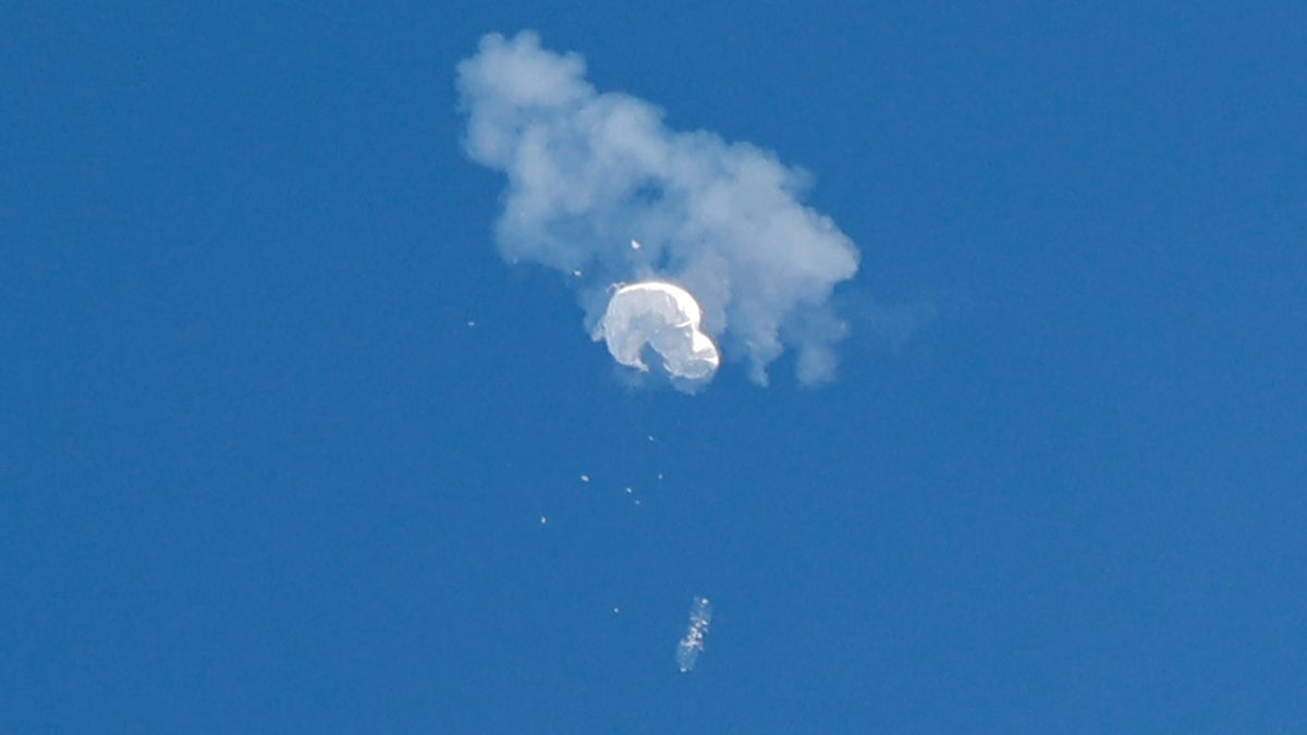 The suspected Chinese spy balloon drifts to the ocean after being shot down off the coast in Surfside Beach, South Carolina, Feb. 4, 2023.
