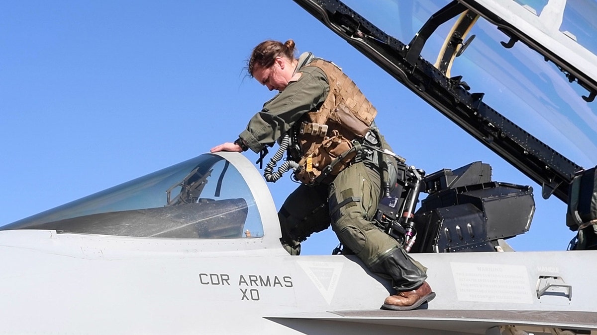 A pilot exiting from the cockpit of a fighter jet