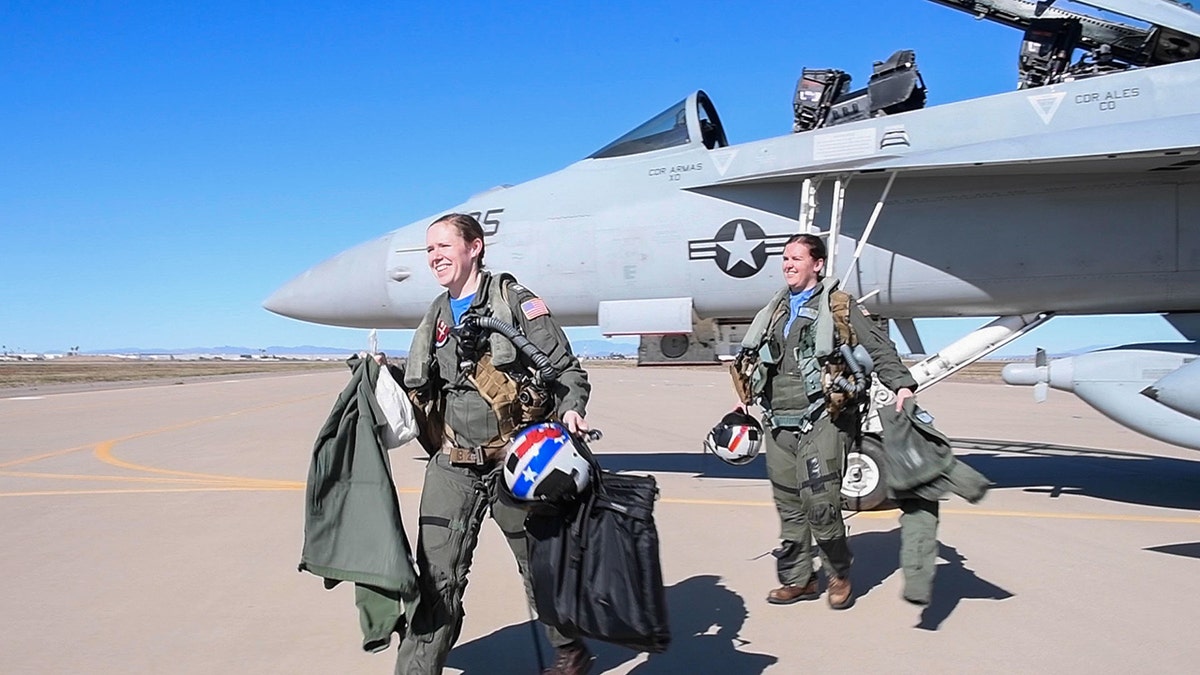 Two pilots exiting a plane