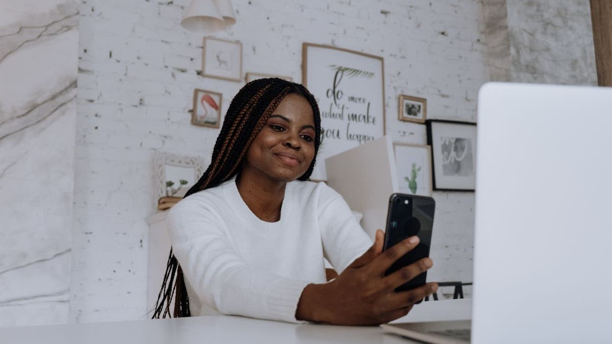 Woman smiling at iPhone