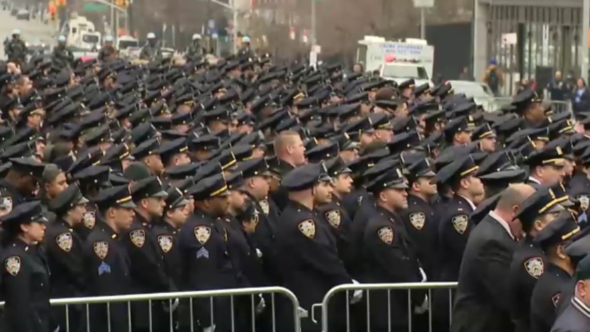 sea of officers standing outside mosque 