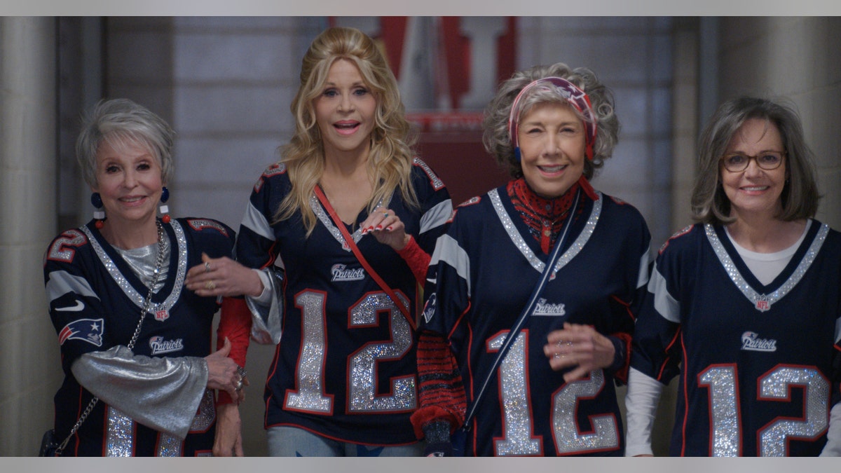 Rita Moreno, Jane Fonda, Lily Tomlin, and Sally Field wear jerseys in still from "80 for Brady"