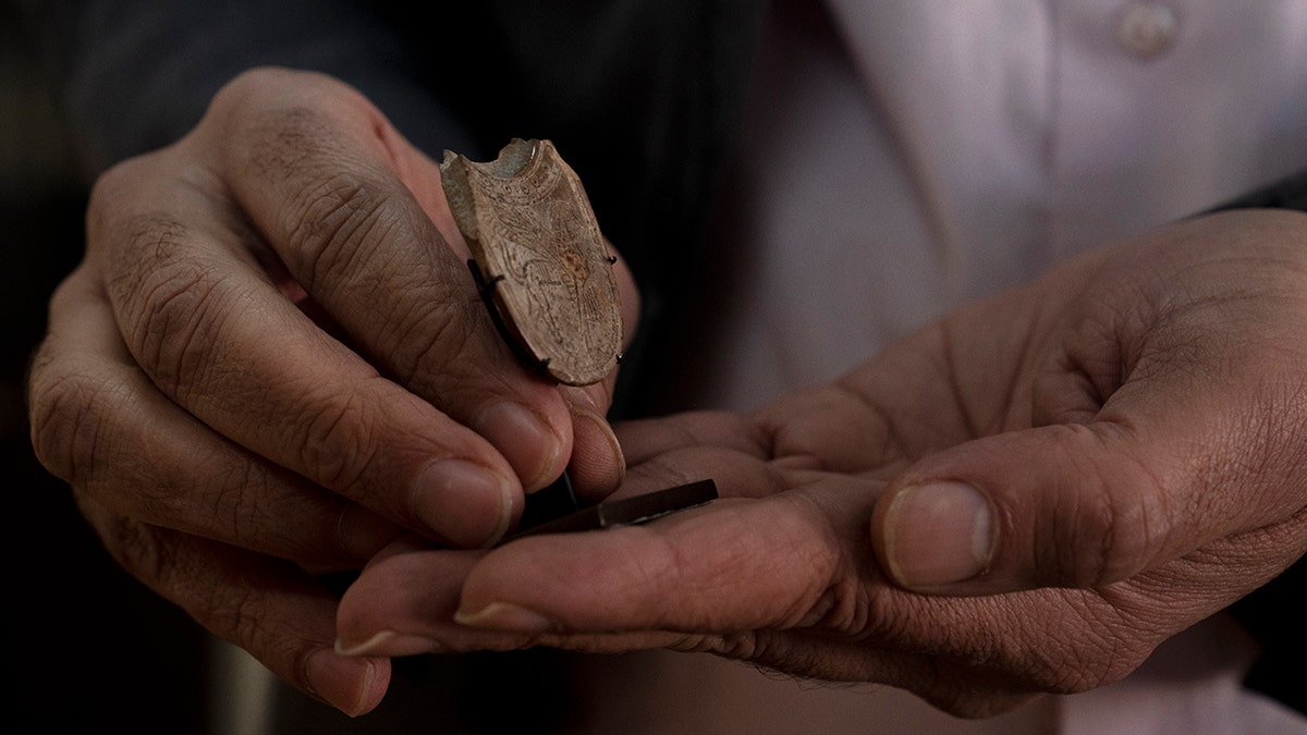 Someone holding the artifact-spoon