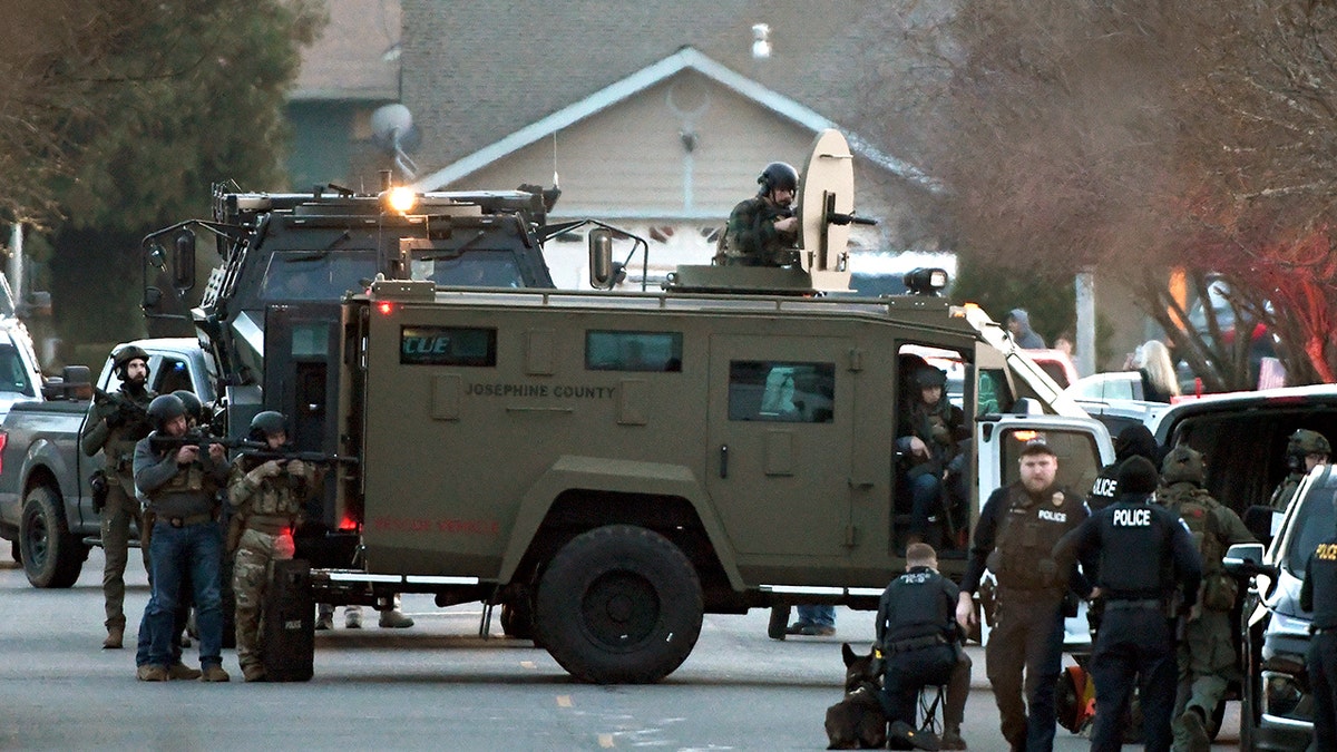 SWAT and others outside Foster's home