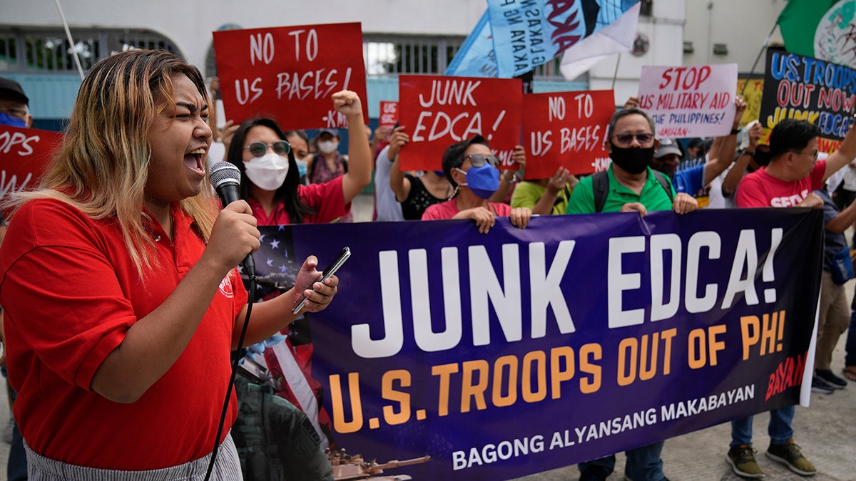 Protesters holding signs calling for the removal of US troops