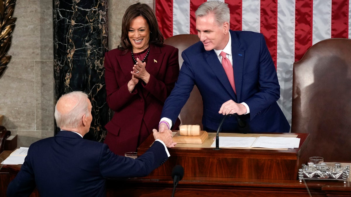 President Joe Biden shakes hands