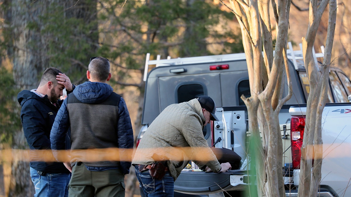 Officials behind police tape