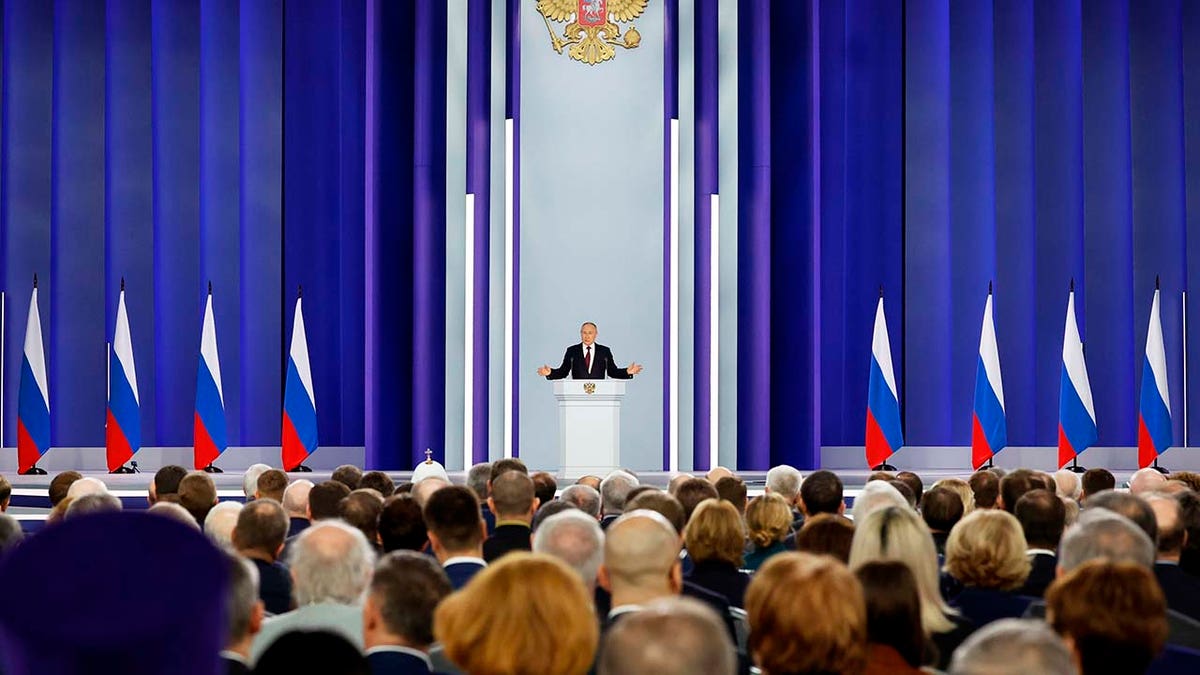 Russian President Vladimir Putin gives a speech to a crowd.