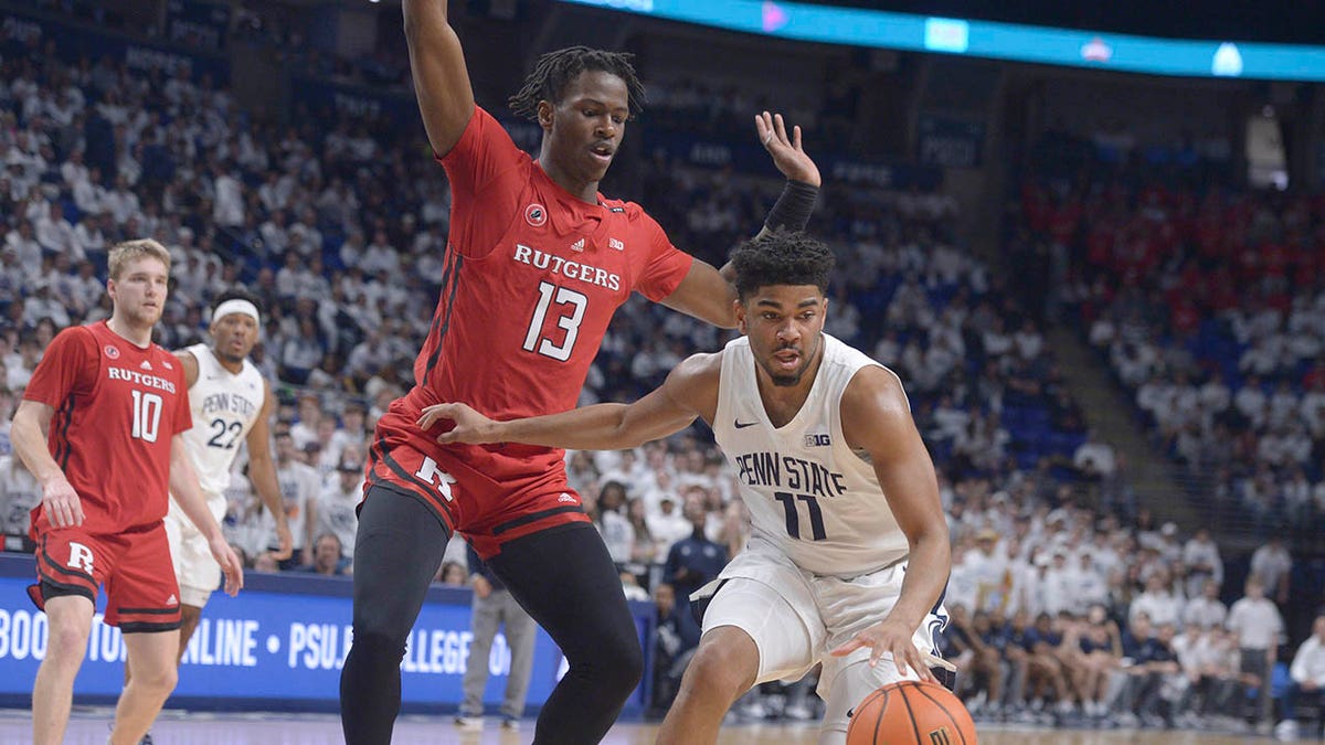 Rutgers' Antwone Woolfolk defends against a Penn State player