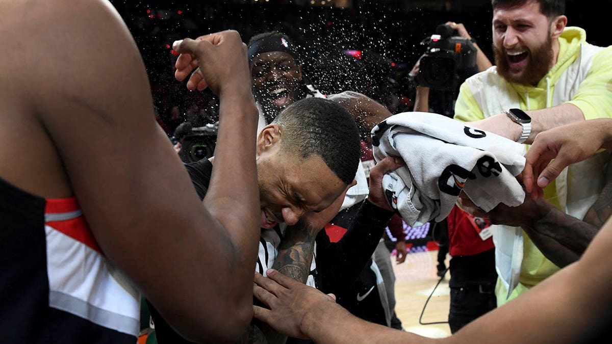 Damian Lillard celebrates scoring a career-high 71 points