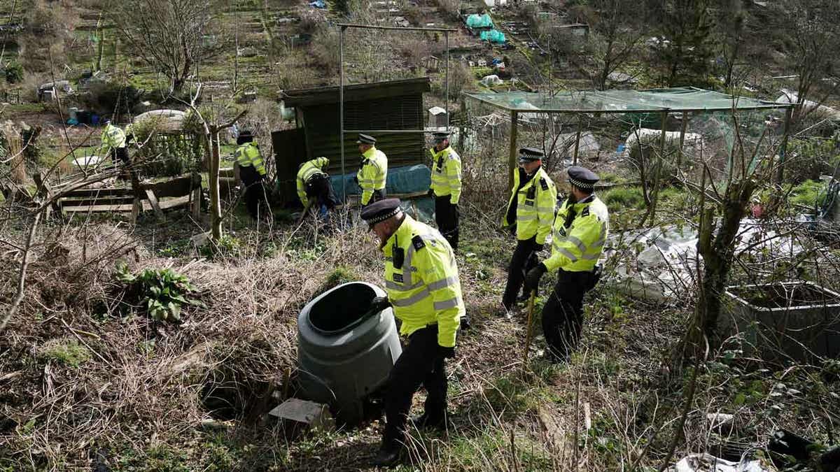 Police officers search