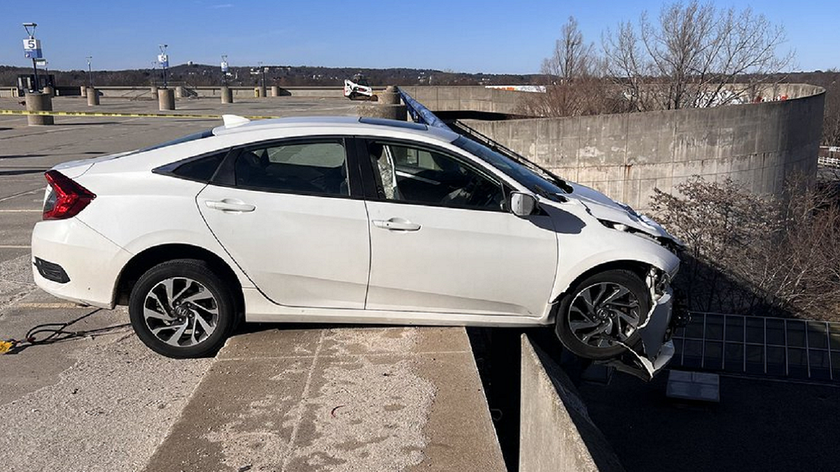 Car crashes in parking garage barrier in Massachusetts