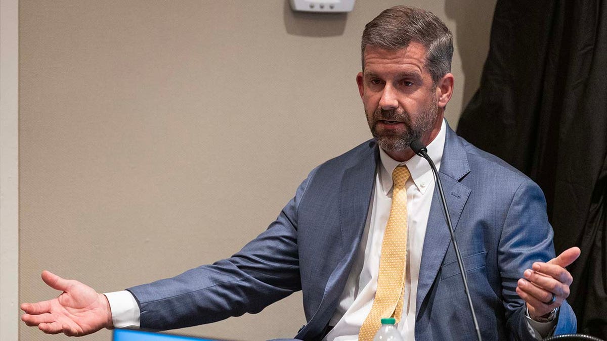 A man answers questions from the witness stand in a trial.