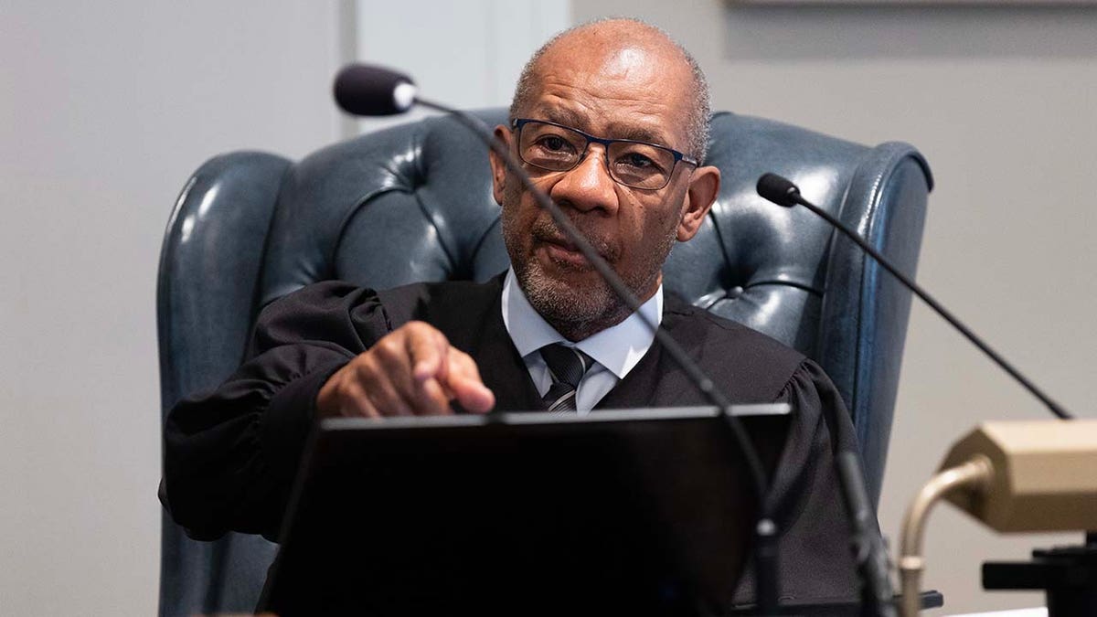 A judge sits in a courtroom.