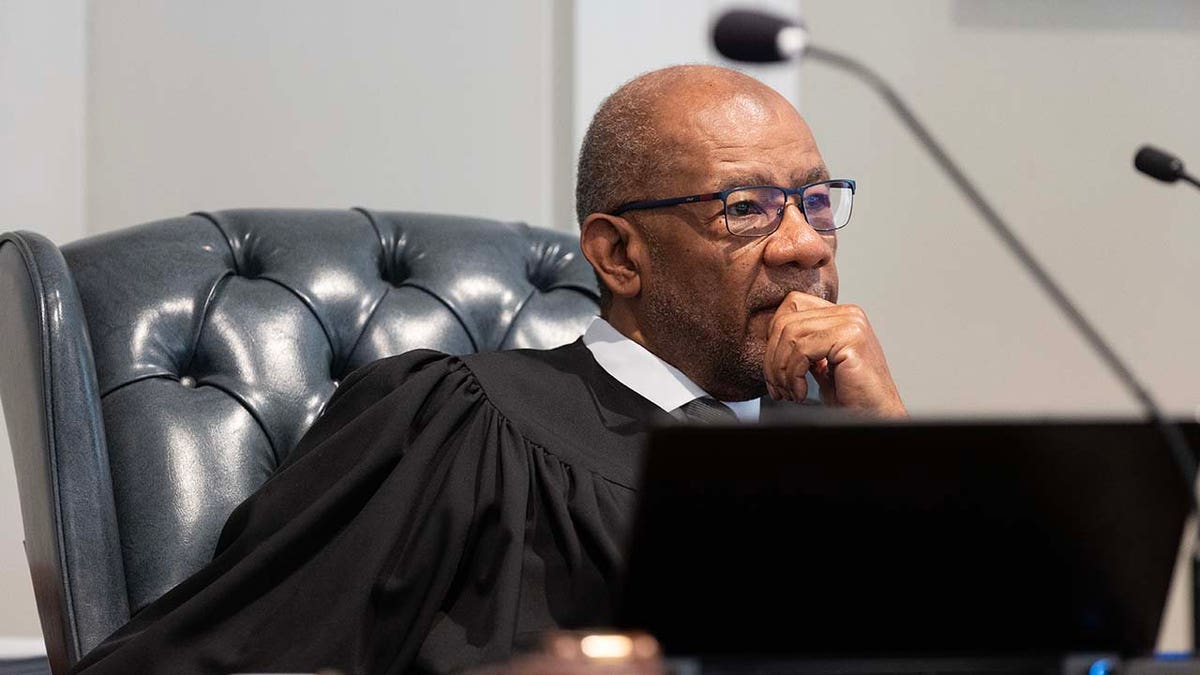 A judge sits in a courtroom.