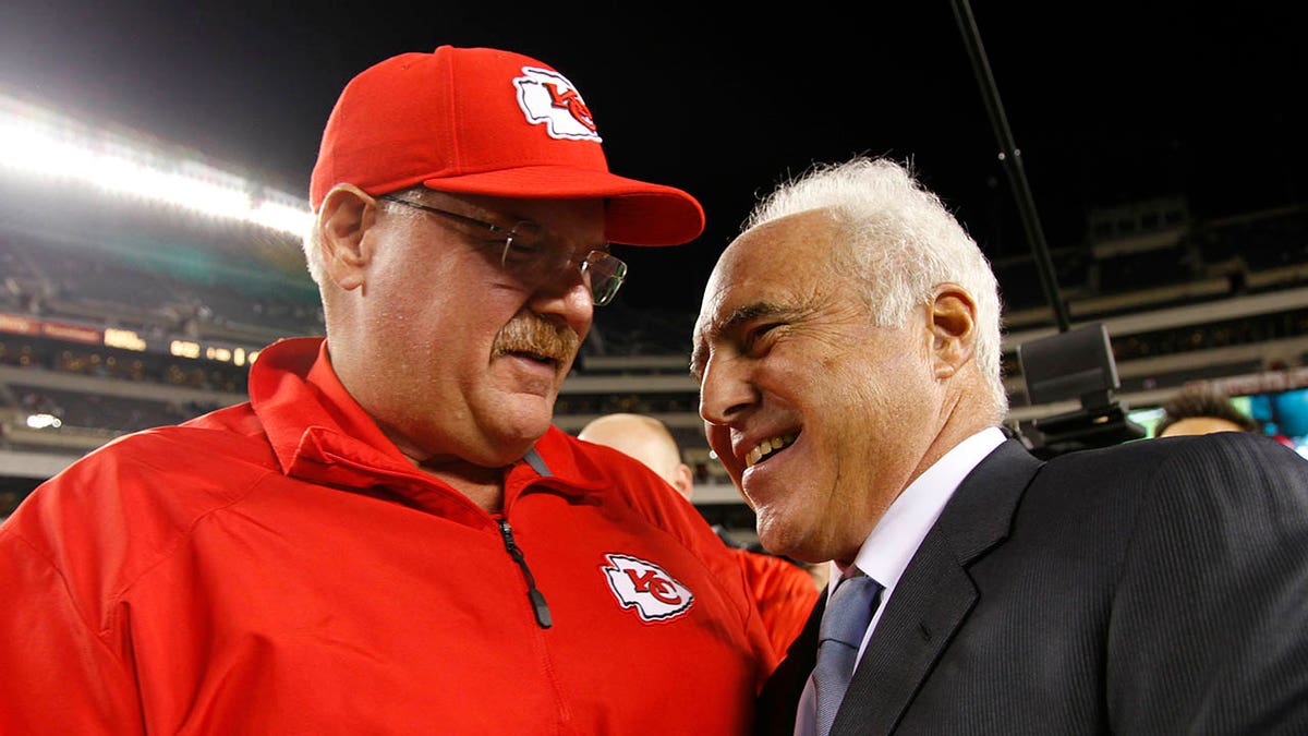 Jeffrey Lurie embraces Andy Reid during an NFL game in 2013