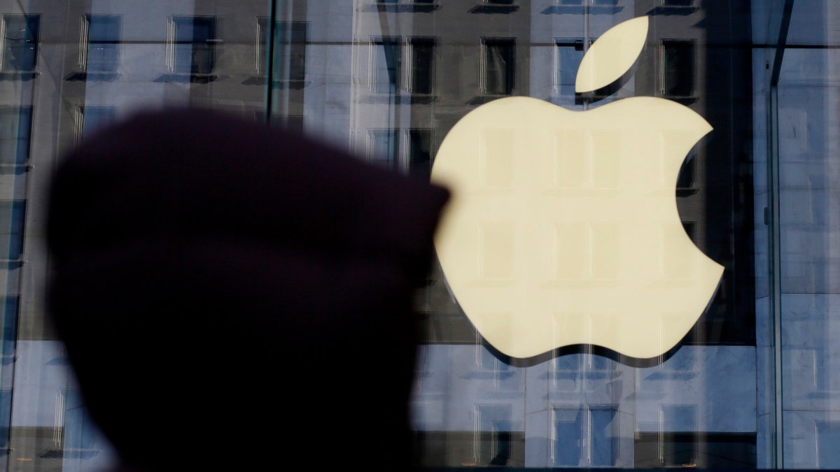 A person walks near the Apple store in New York, New York