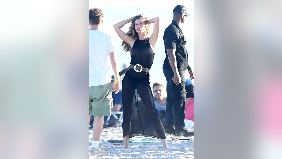 Gisele poses in a black see-through outfit