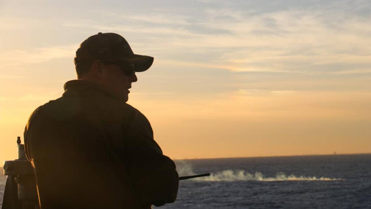 Servicemember looks out to the sea