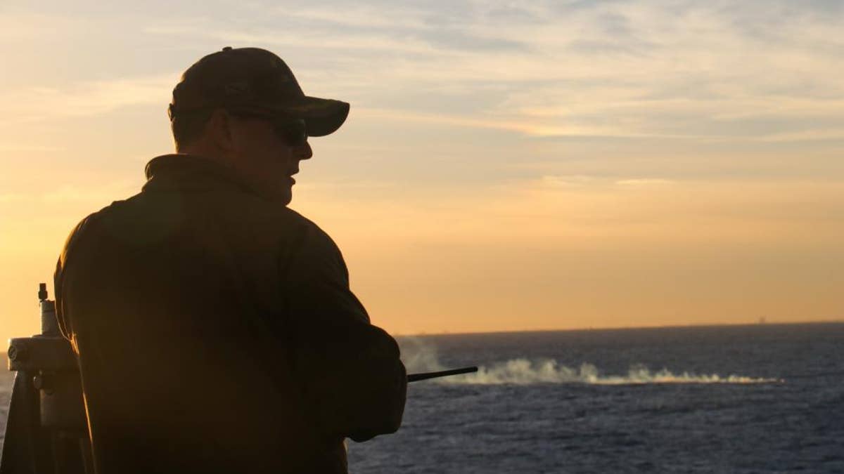 Servicemember looks out to the sea