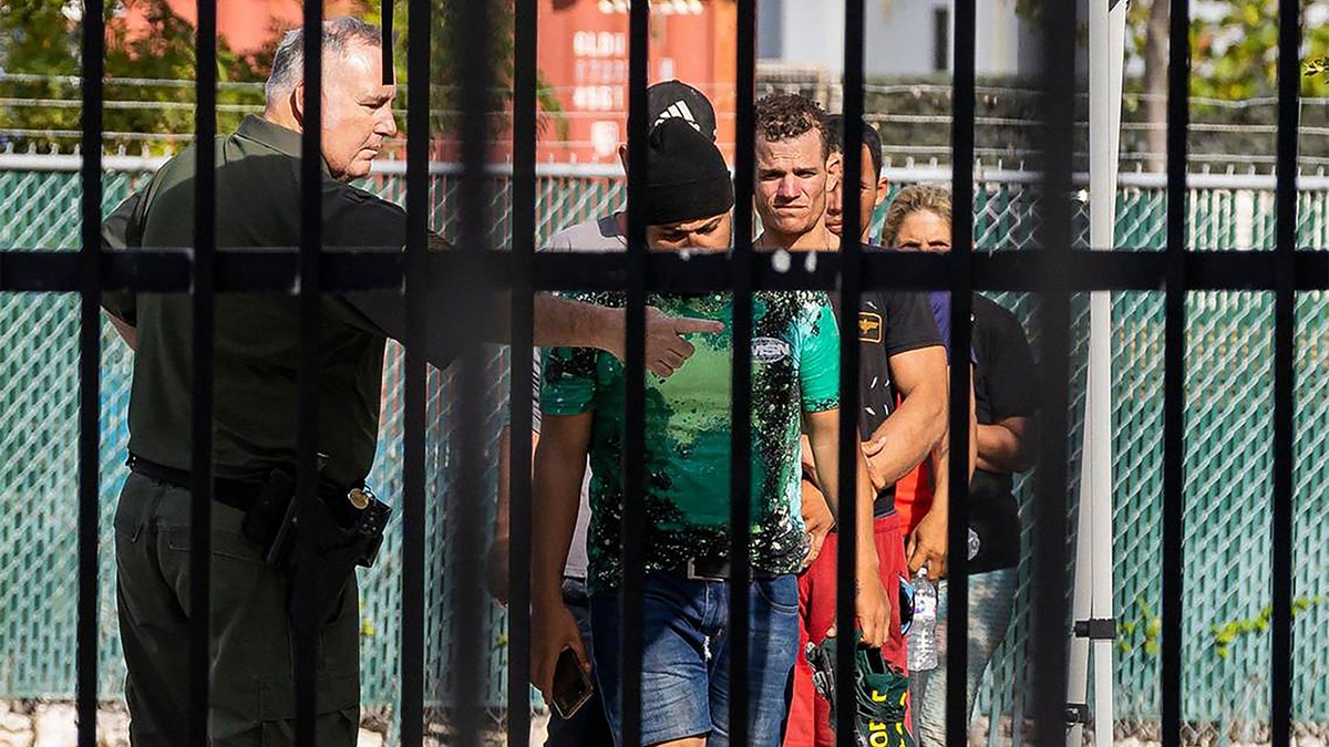 U.S. Border Patrol agent is seen with Cuban migrants