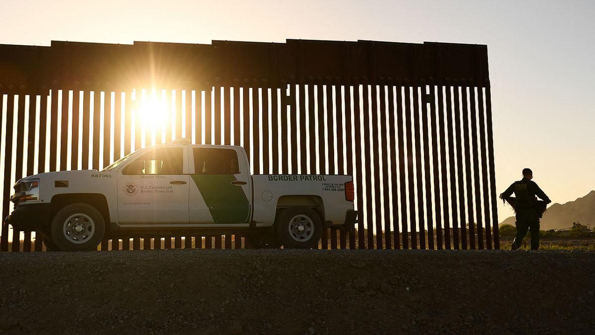 Border patrol truck at border fence