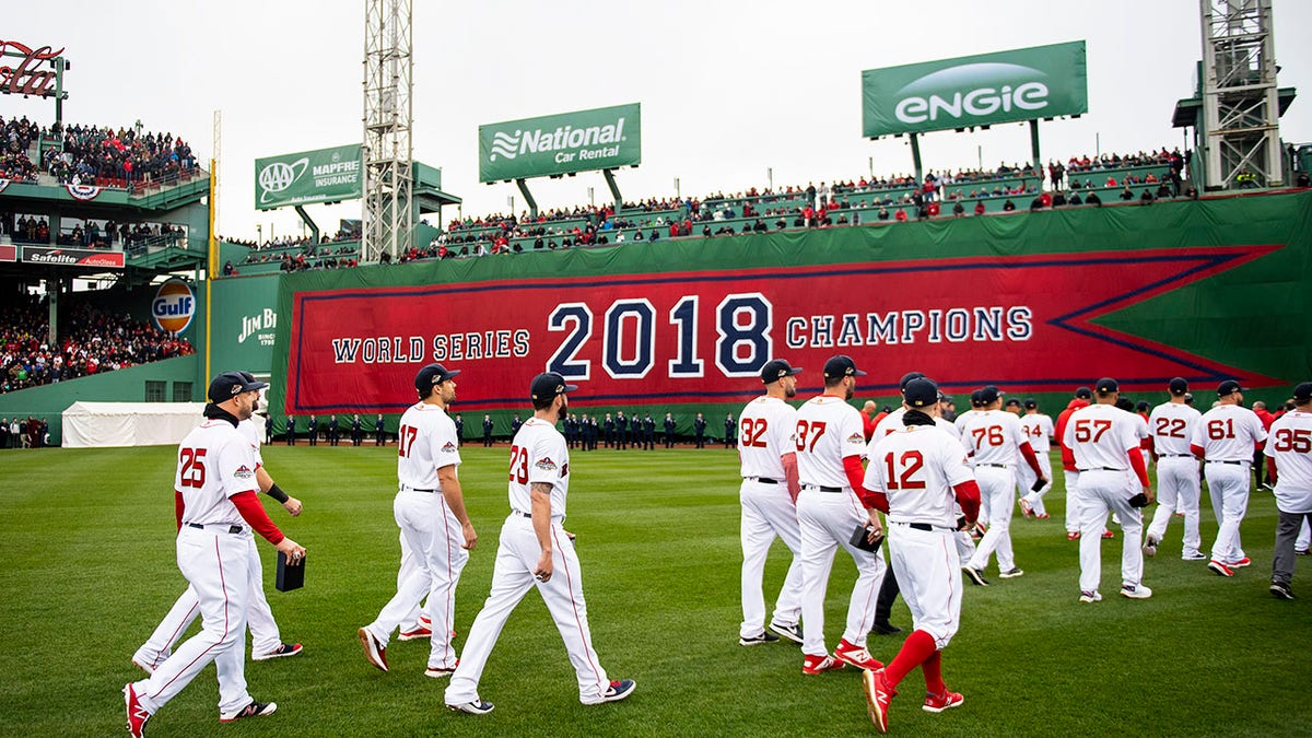 Boston Red Sox players walk toward the outfield