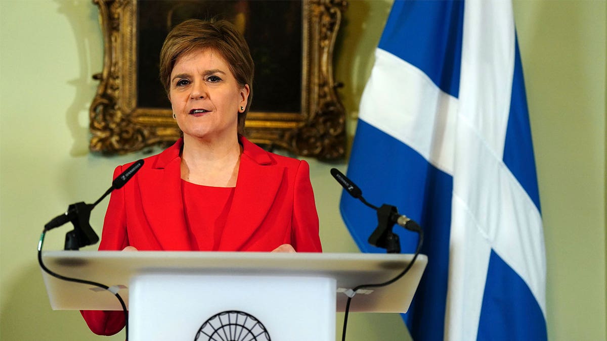 Nicola Sturgeon standing at a podium giving a speech.