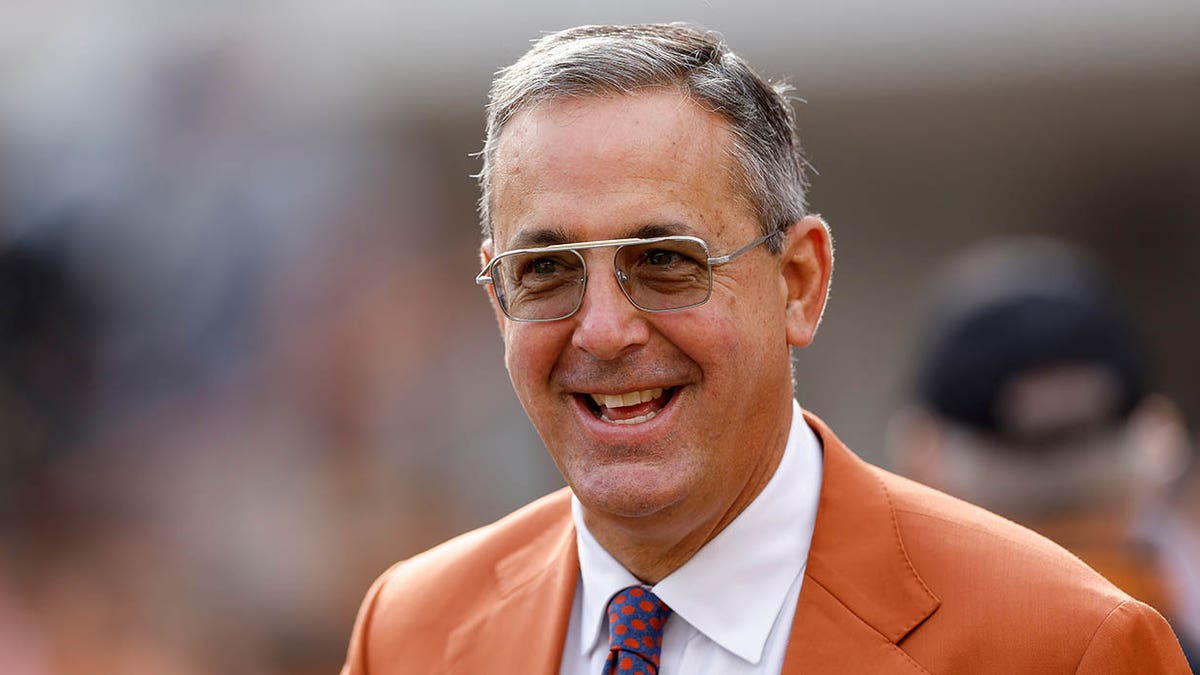 Chris Del Conte smiles on field