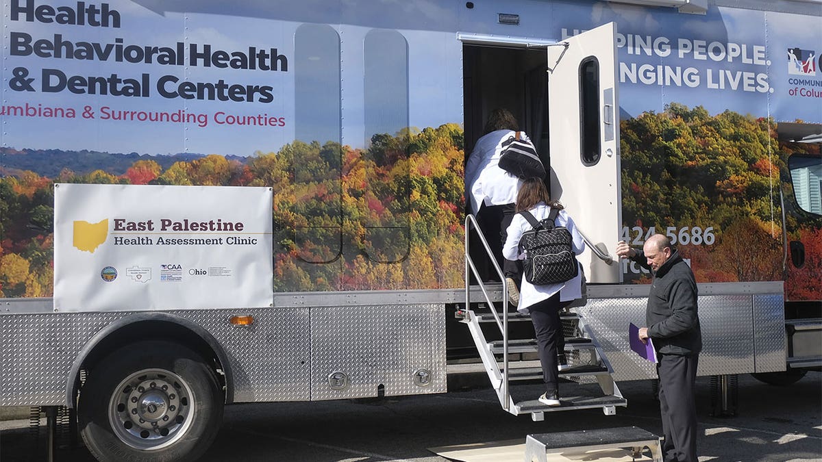 Residents walking into a mobile health center in East Palestine, Ohio.