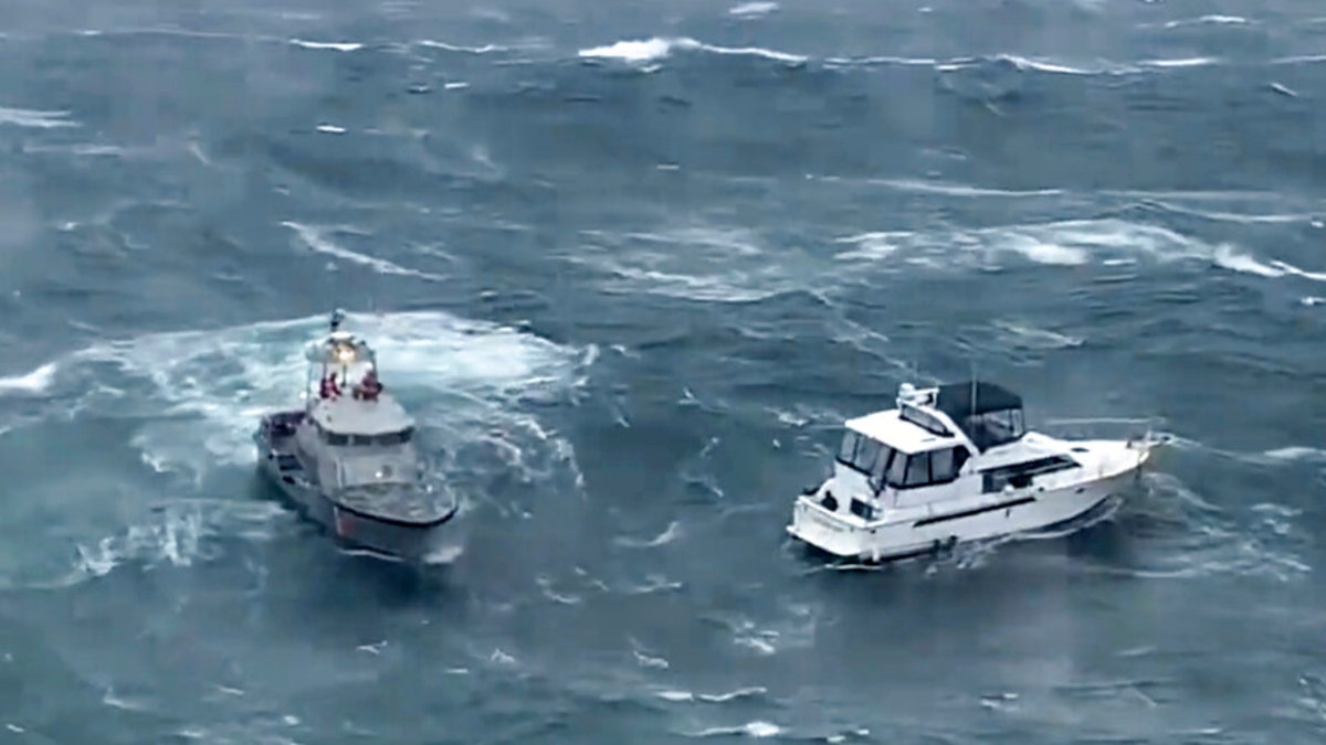 A Coast Guard ship attempts to a rescue a distressed yacht