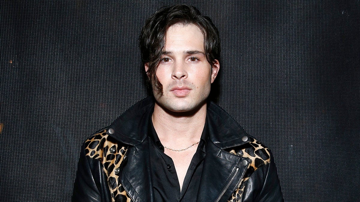 Cody Longo wears black leather jacket embroidered with leopard print