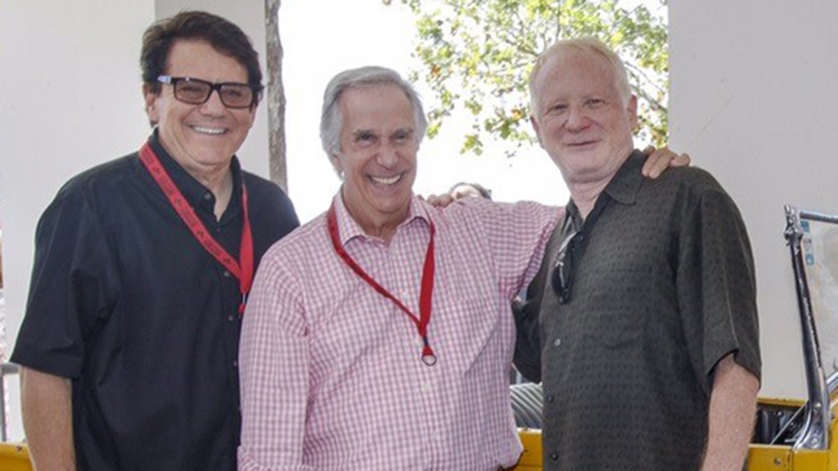 Anson Williams, Henry Winkler and Don Most smiling at the camera