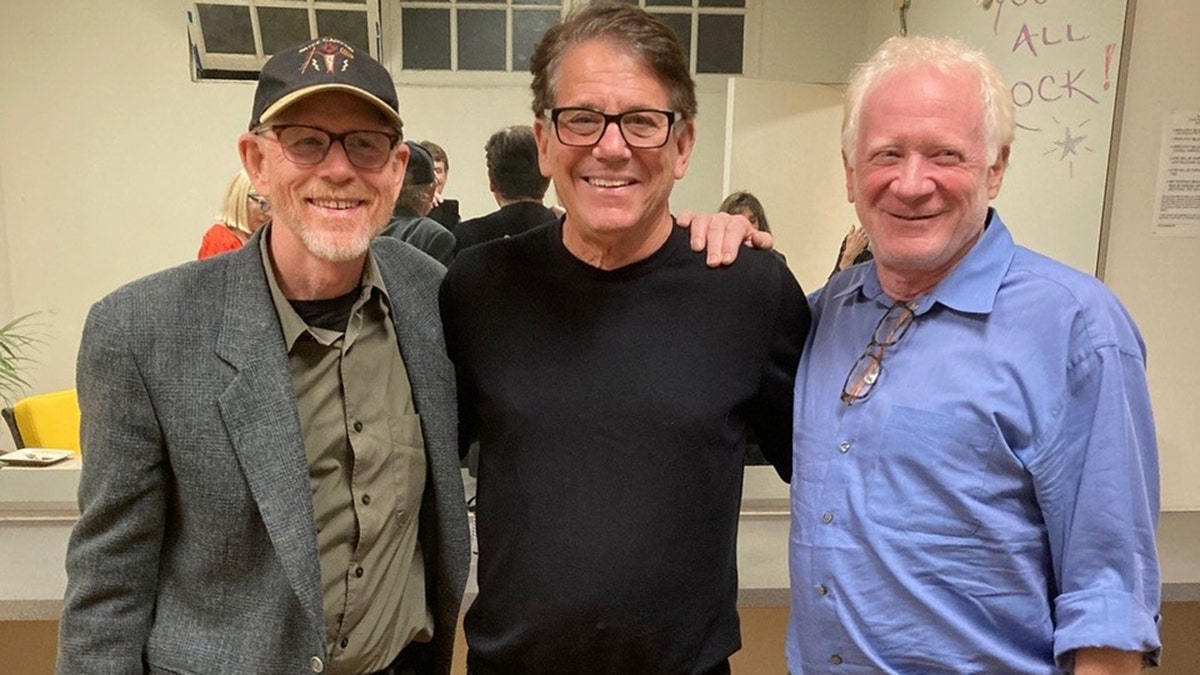 Ron Howard, Anson Williams and Don Most smiling at the camera