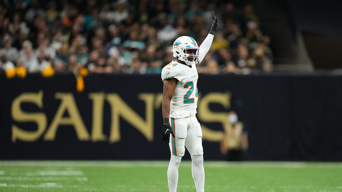 Byron Jones raises his arm during an NFL game