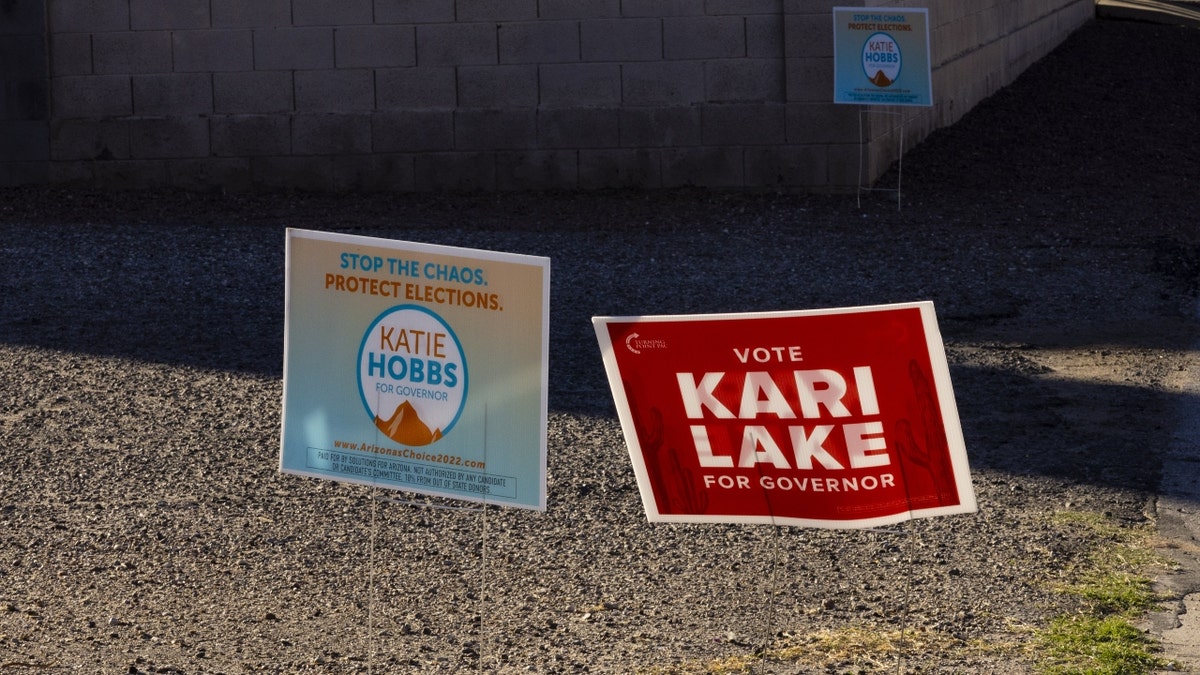 Campaign signs for Katie Hobbs and Kari Lake