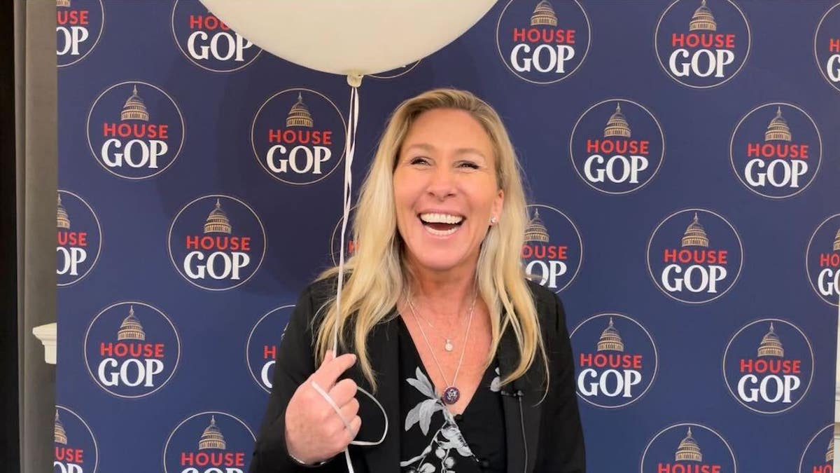 Rep. Marjorie Taylor Greene, R-Ga., poses with a balloon ahead of President Biden's State of the Union address Tuesday.