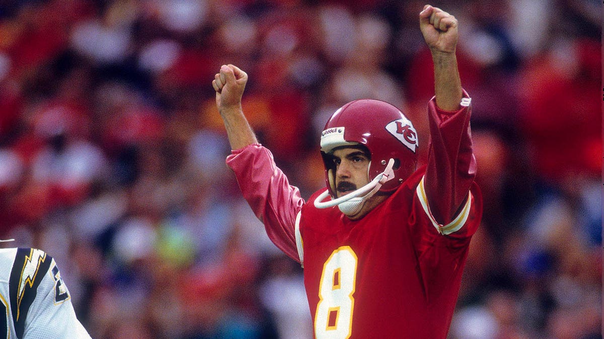 Nick Lowery celebrates making a field goal during an NFL game in 1989