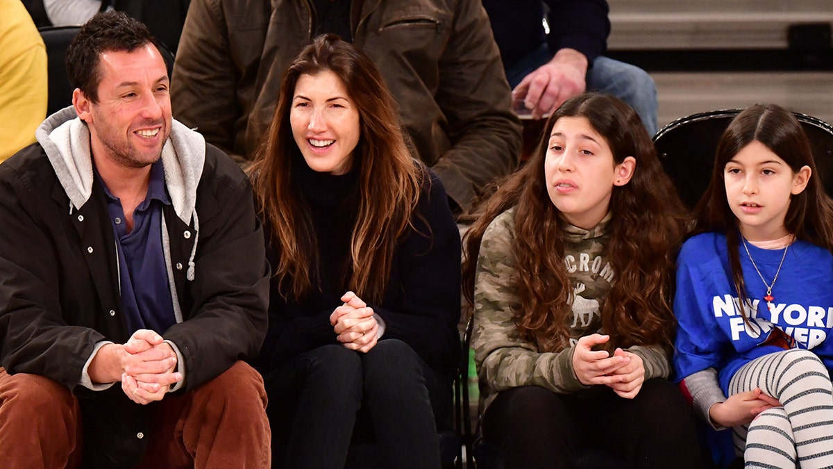 Adam Sandler and his family at a basketball game