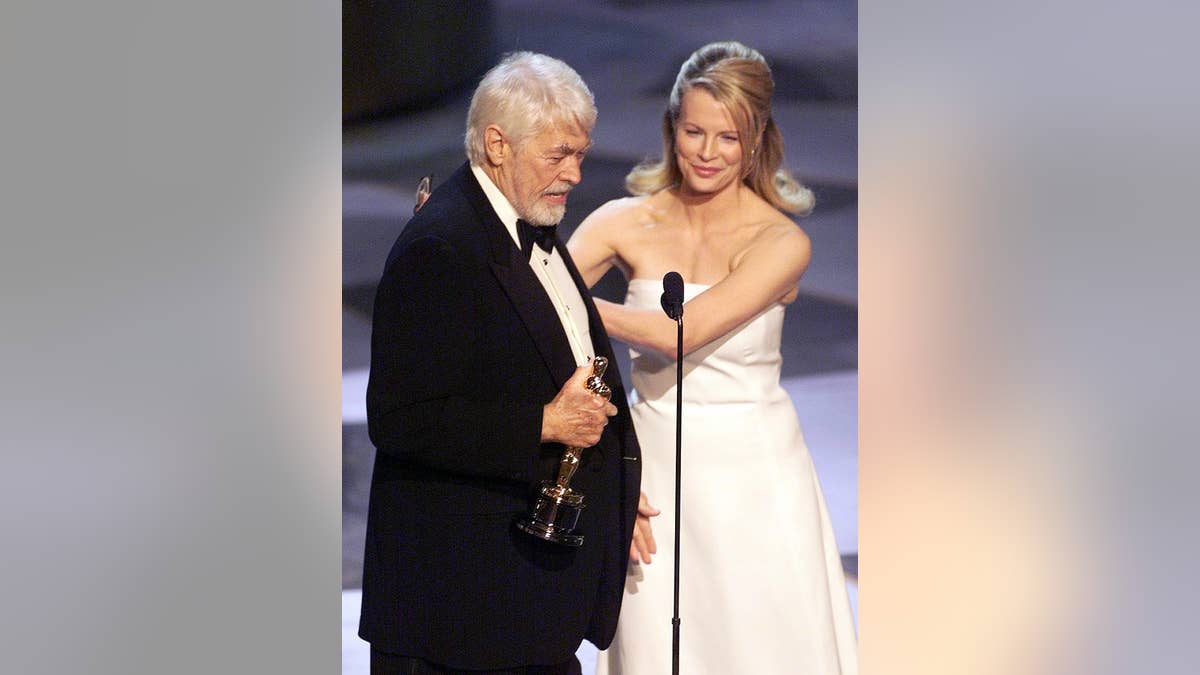 Kim Basinger presents award to James Coburn