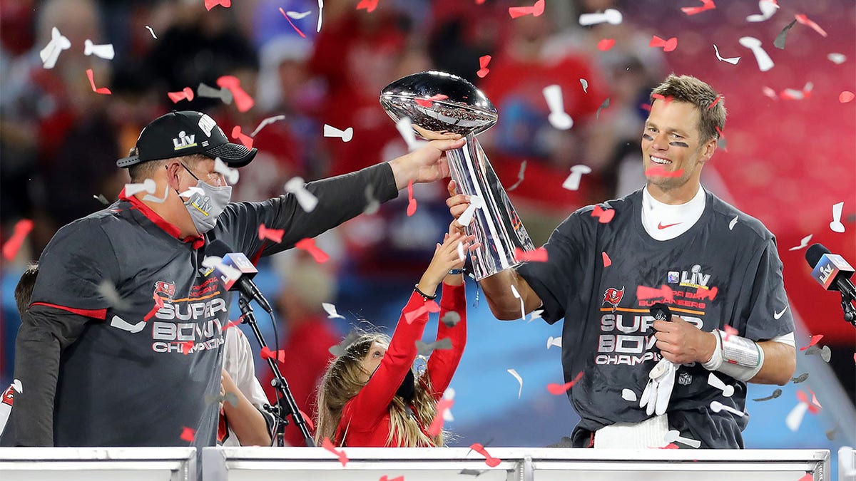 Tom Brady accepts the Super Bowl trophy