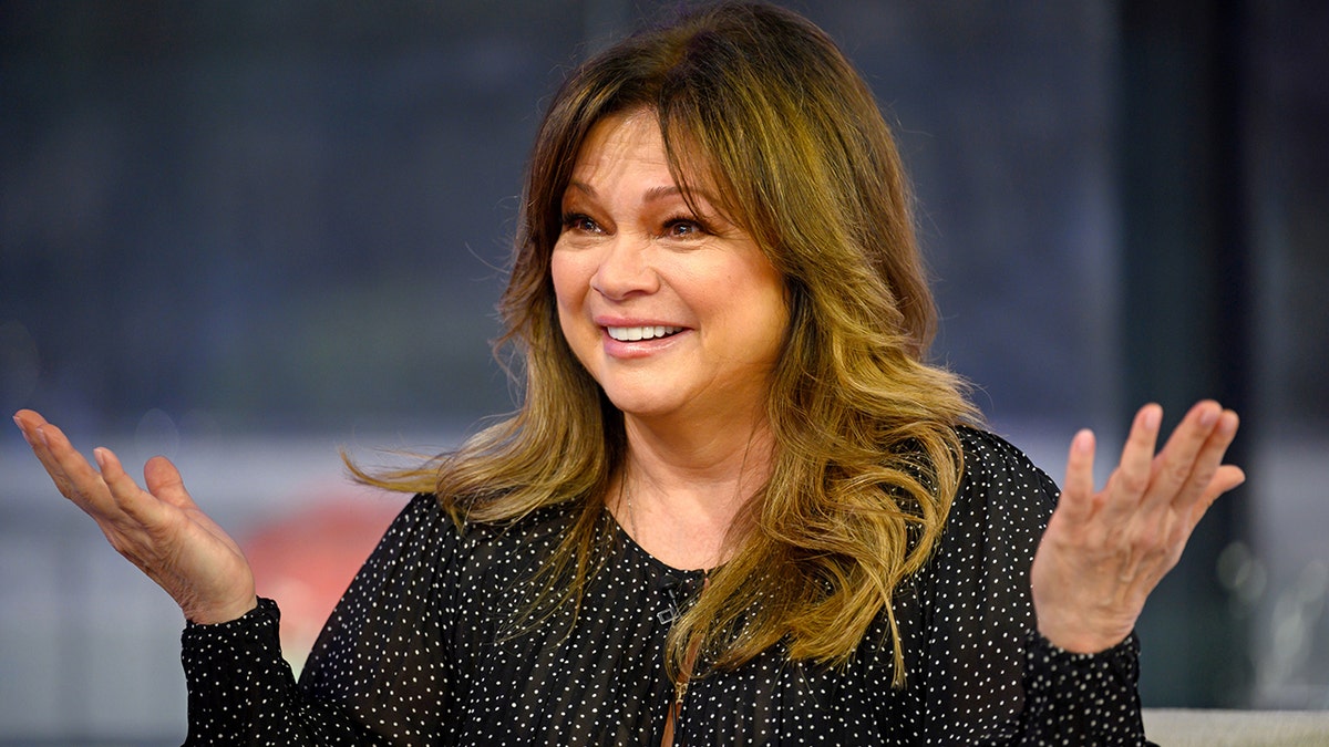 Valerie Bertinelli in a black sparkled top with her hands up in the air while on TODAY