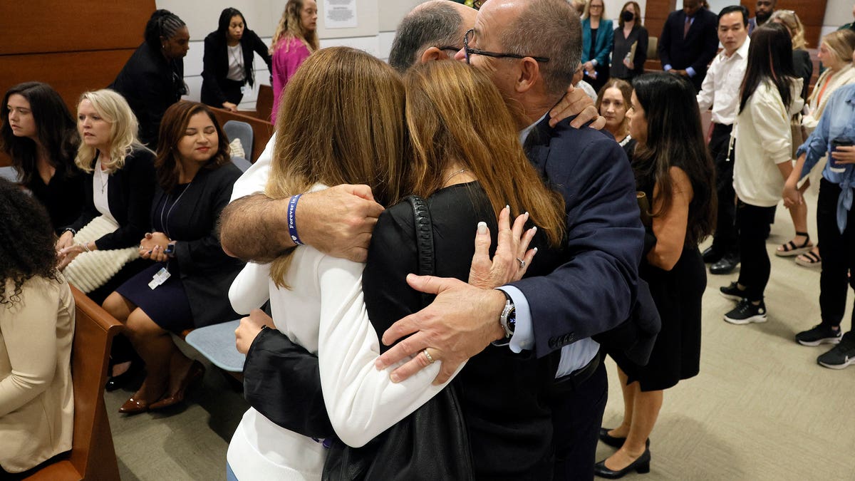 FILE – Linda Beigel Schulman, Michael Schulman, Patricia Padauy Oliver and Fred Guttenberg, family members of the victims, hug inside the courtroom for an expected verdict in the penalty phase of the trial of Marjory Stoneman Douglas High School shooter Nikolas Cruz at the Broward County Courthouse in Fort Lauderdale, Florida on October 13, 2022. - Cruz, who shot and killed 17 people at a Florida high school in 2018, planned and carried out a "systematic massacre," a prosecutor arguing for the death penalty said.