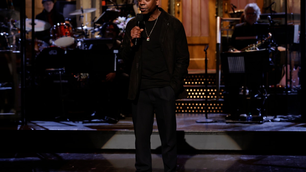 Dave Chappelle wearing black on SNL monologue stage