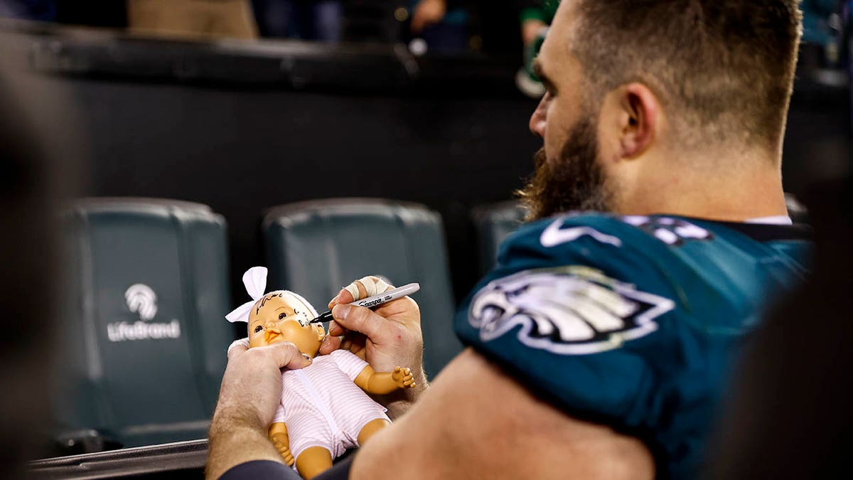 Jason Kelce signs a babydoll