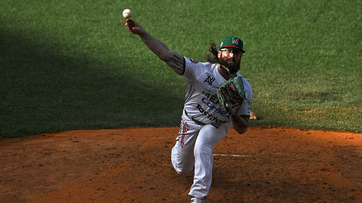 Matt Pobereyko throws a pitch during a game in Mexico