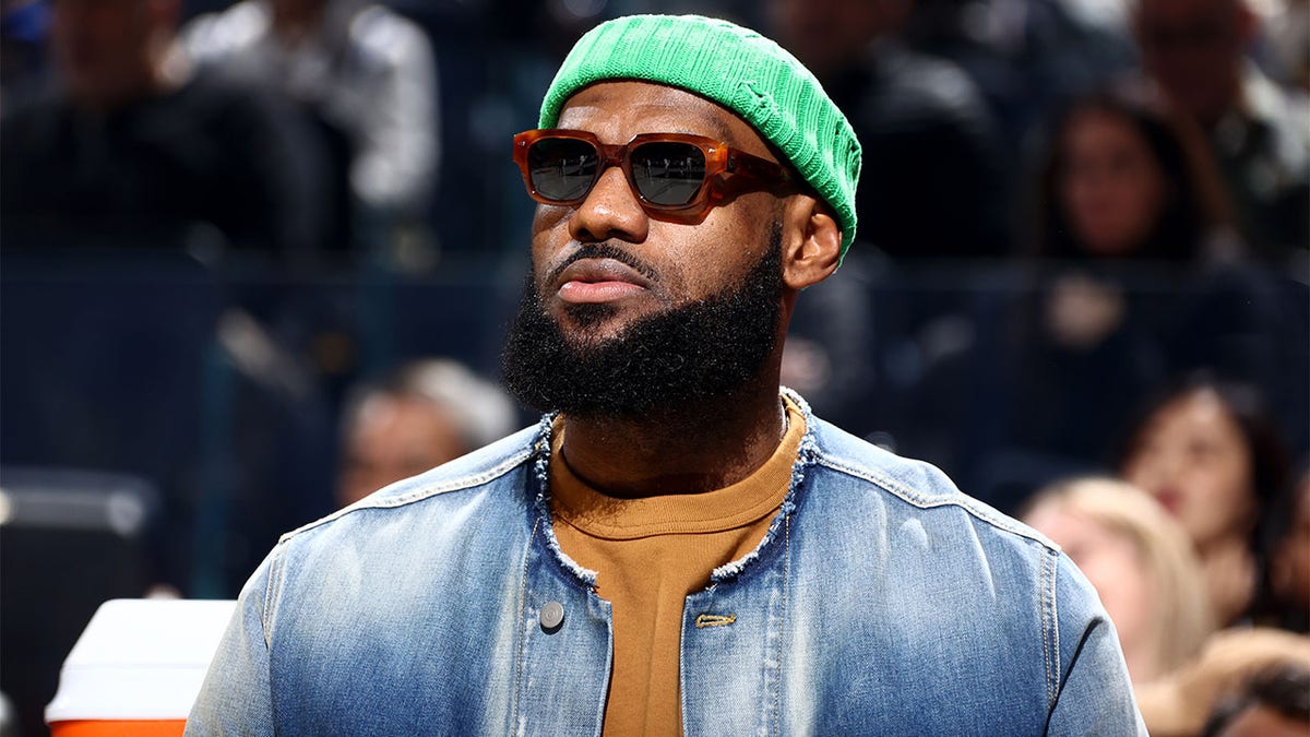 LeBron James watches the Lakers play the Warriors